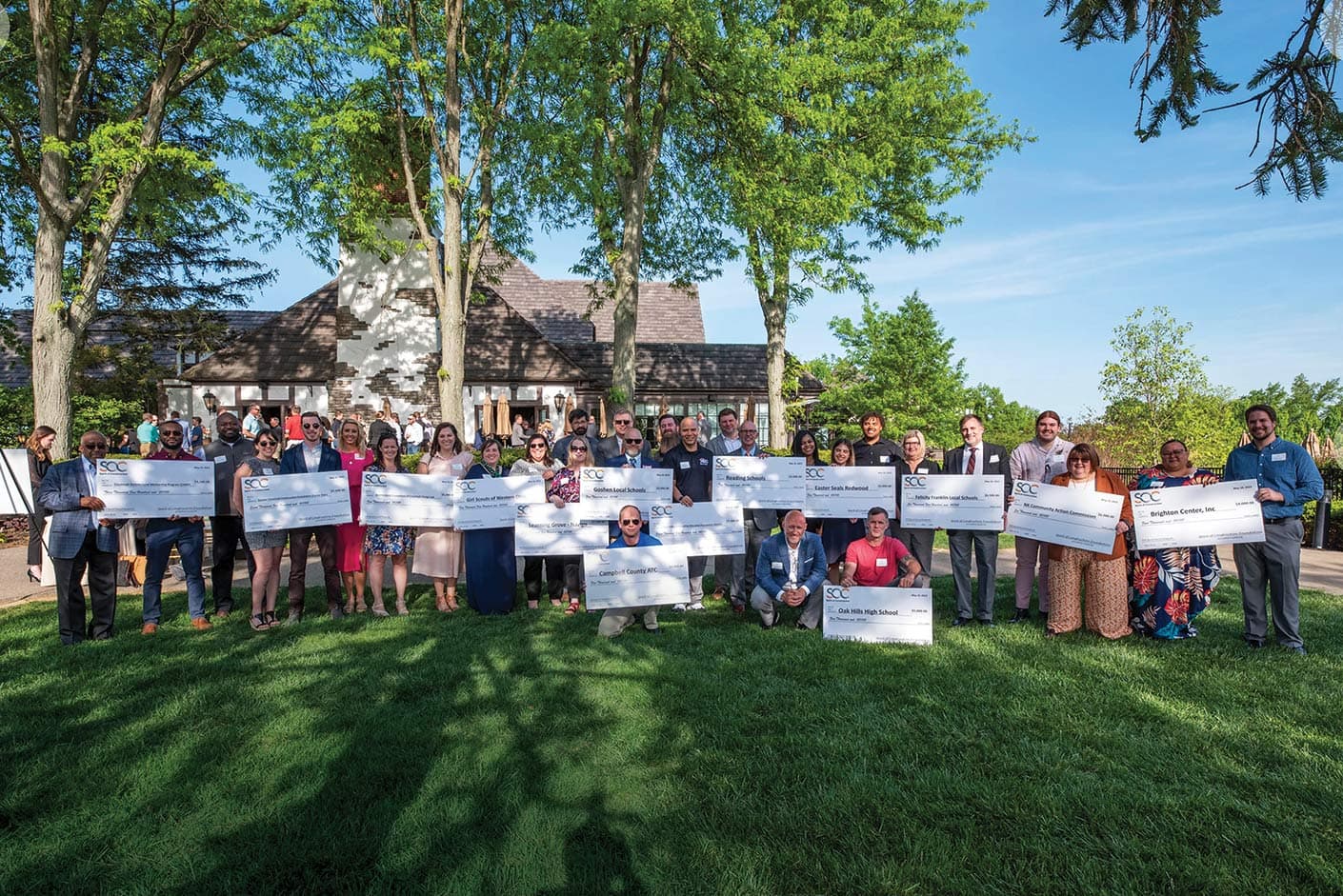 Recipients smiling with their grant checks at the Spring Fling Event