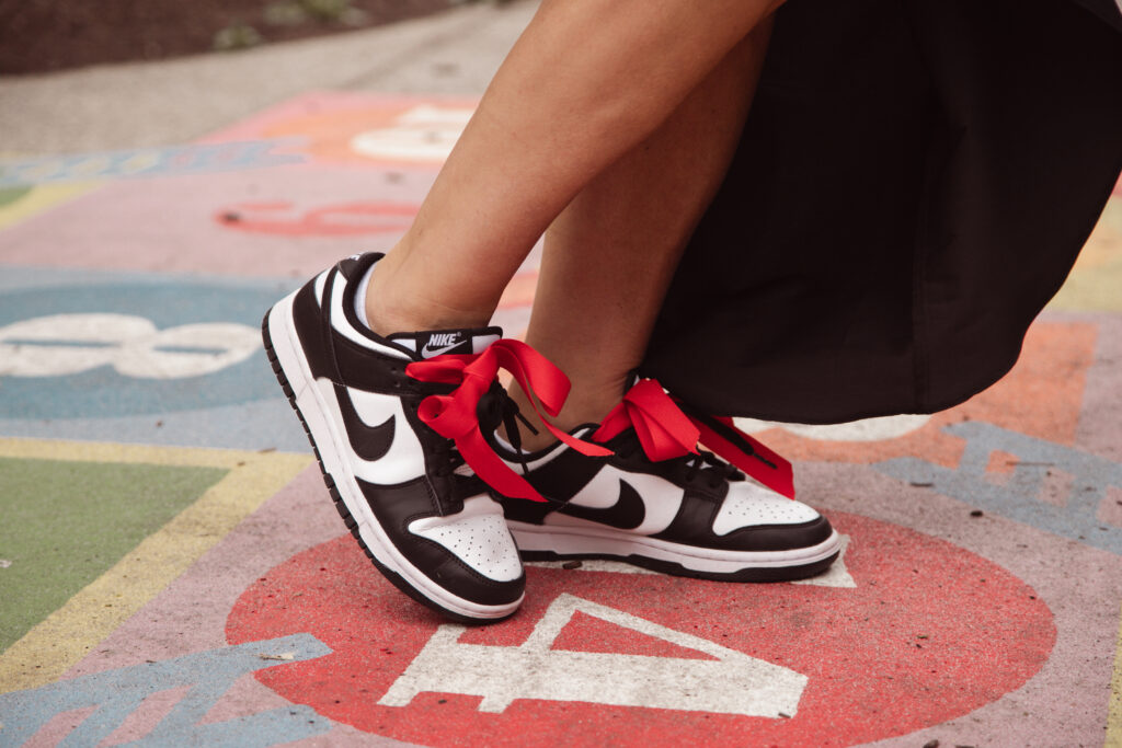 Close up of black and white sneakers with pink shoe laces